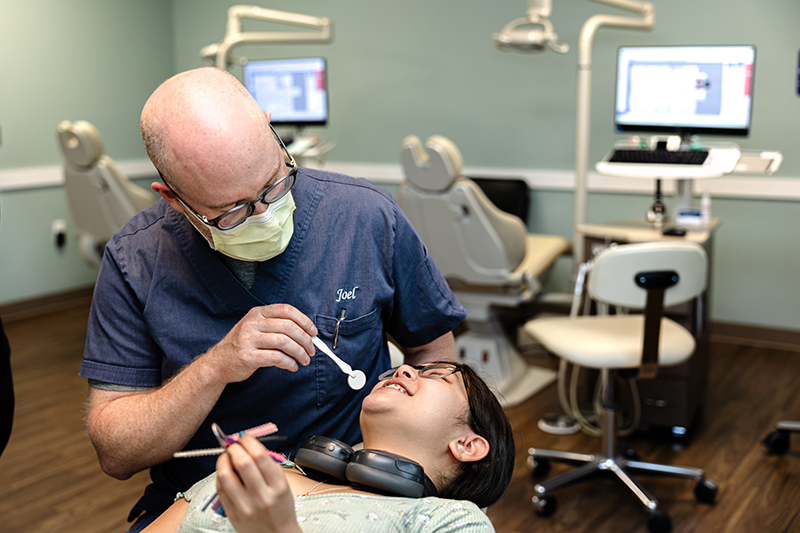 Dr. Joel Silman attends to a patient at the Exeter Smiles Allentown, PA location
