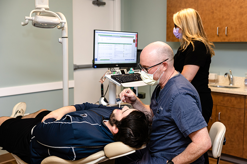 Dr. Joel Silman of Exeter Smiles works with a patient at the Allentown, PA clinic.